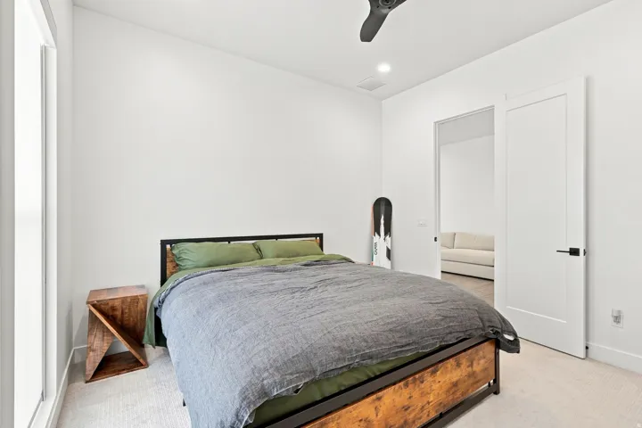 Recessed lighting, ceiling fan, and light-toned carpet flooring