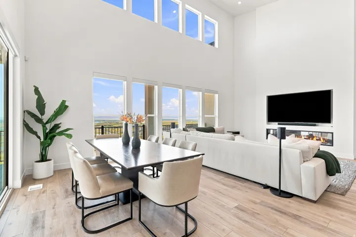 Expansive open-concept living space with high ceilings and wood-finish flooring