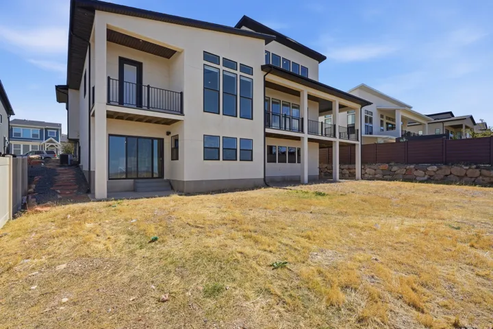 Contemporary exterior with multiple balconies featuring black metal railings
