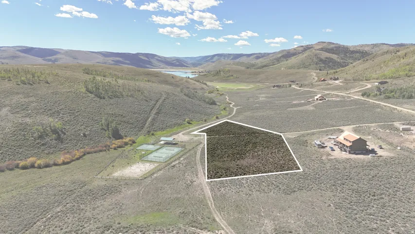 Open land parcel with mountain terrain and a distant body of water