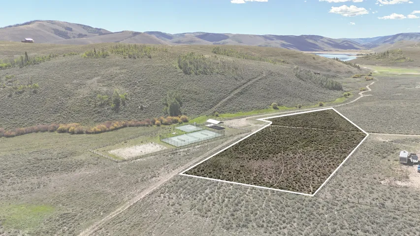 Expansive land parcel featuring open terrain and distant water