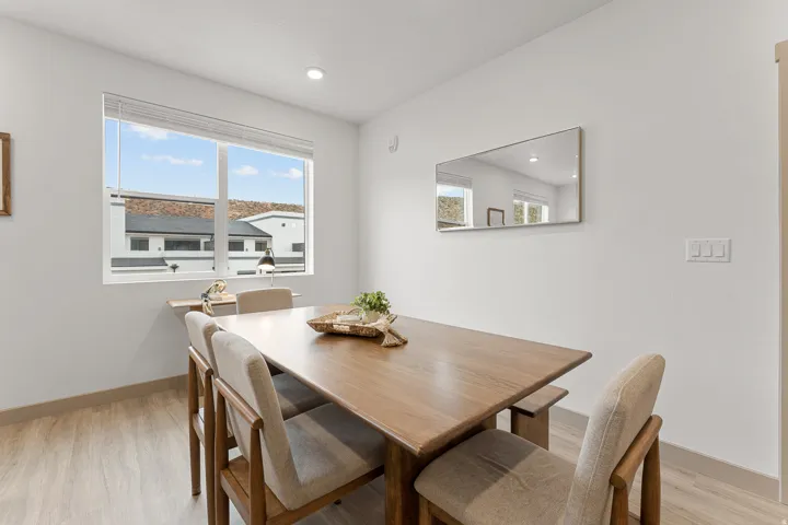 Recessed lighting accents a large window with white blinds, offering abundant natural illumination