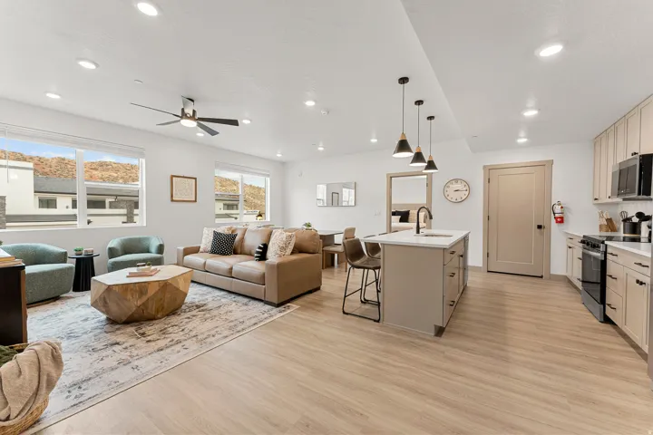 Open-concept living space with recessed lighting and a ceiling fan