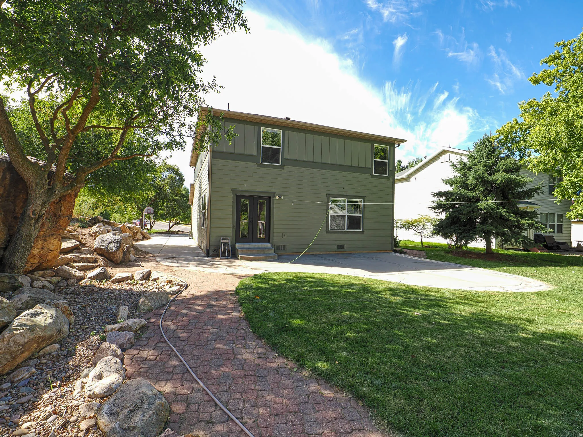 Two-story exterior with dual-pane windows and a neutral siding finish