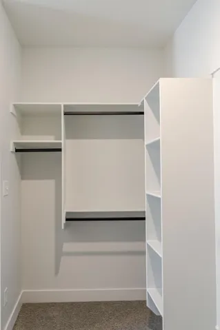Built-in closet system featuring multiple shelves and hanging rods