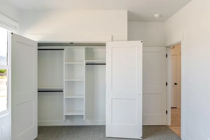Integrated closet system featuring multiple shelves and hanging rods