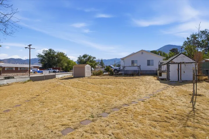 Expansive outdoor area with a utility shed and a separate outbuilding