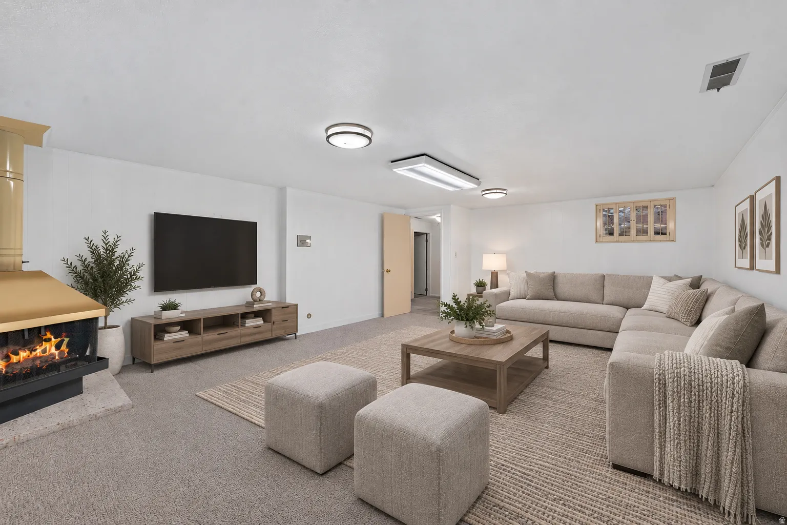 Carpeted floor, built-in fireplace, light-toned walls, recessed lighting, and a window with wooden trim