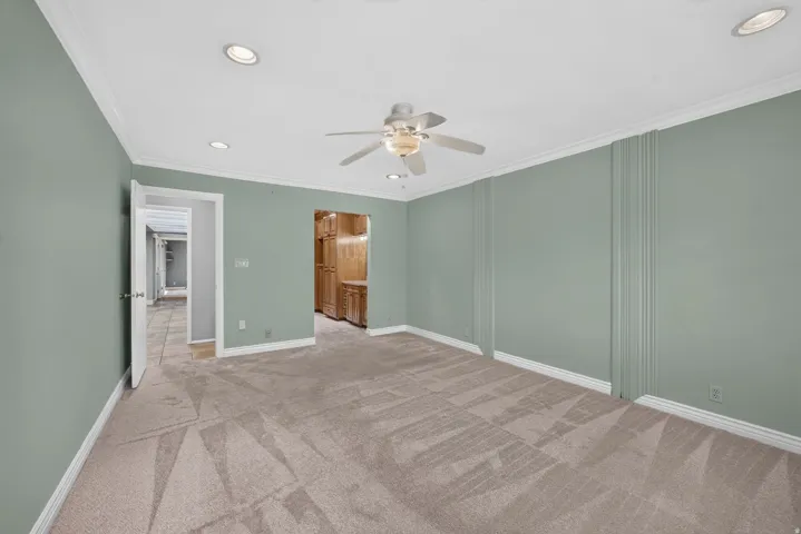 Recessed lighting, crown molding, ceiling fan, and carpeted flooring