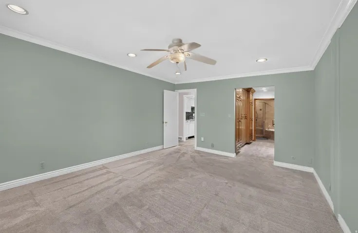 Recessed lighting, crown molding, ceiling fan, and carpeted flooring