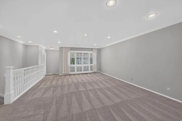 Spacious room with carpet flooring, recessed lighting, and crown molding