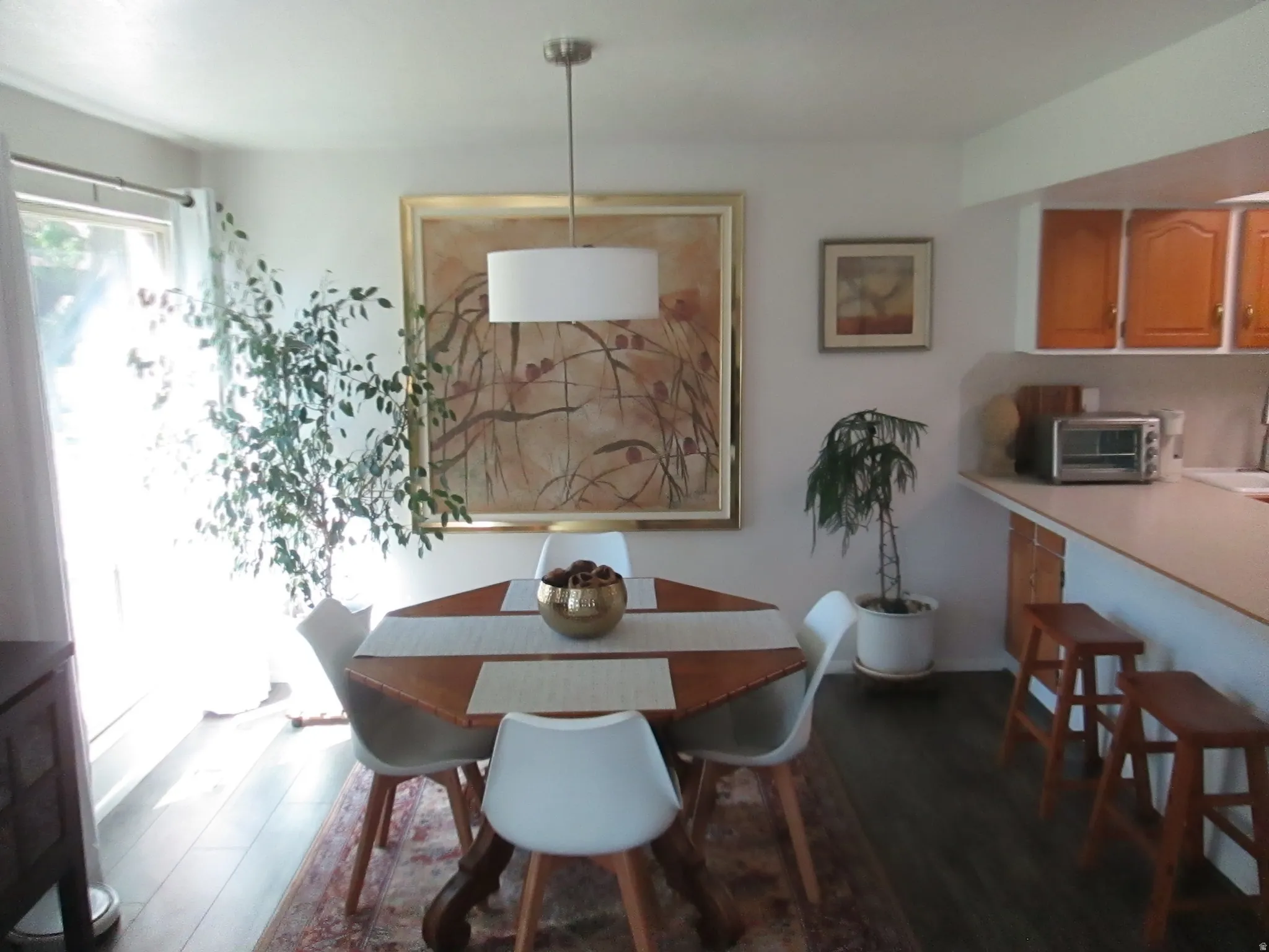 Recessed lighting, wood-finish flooring, and white walls create a neutral palette for personalized decor