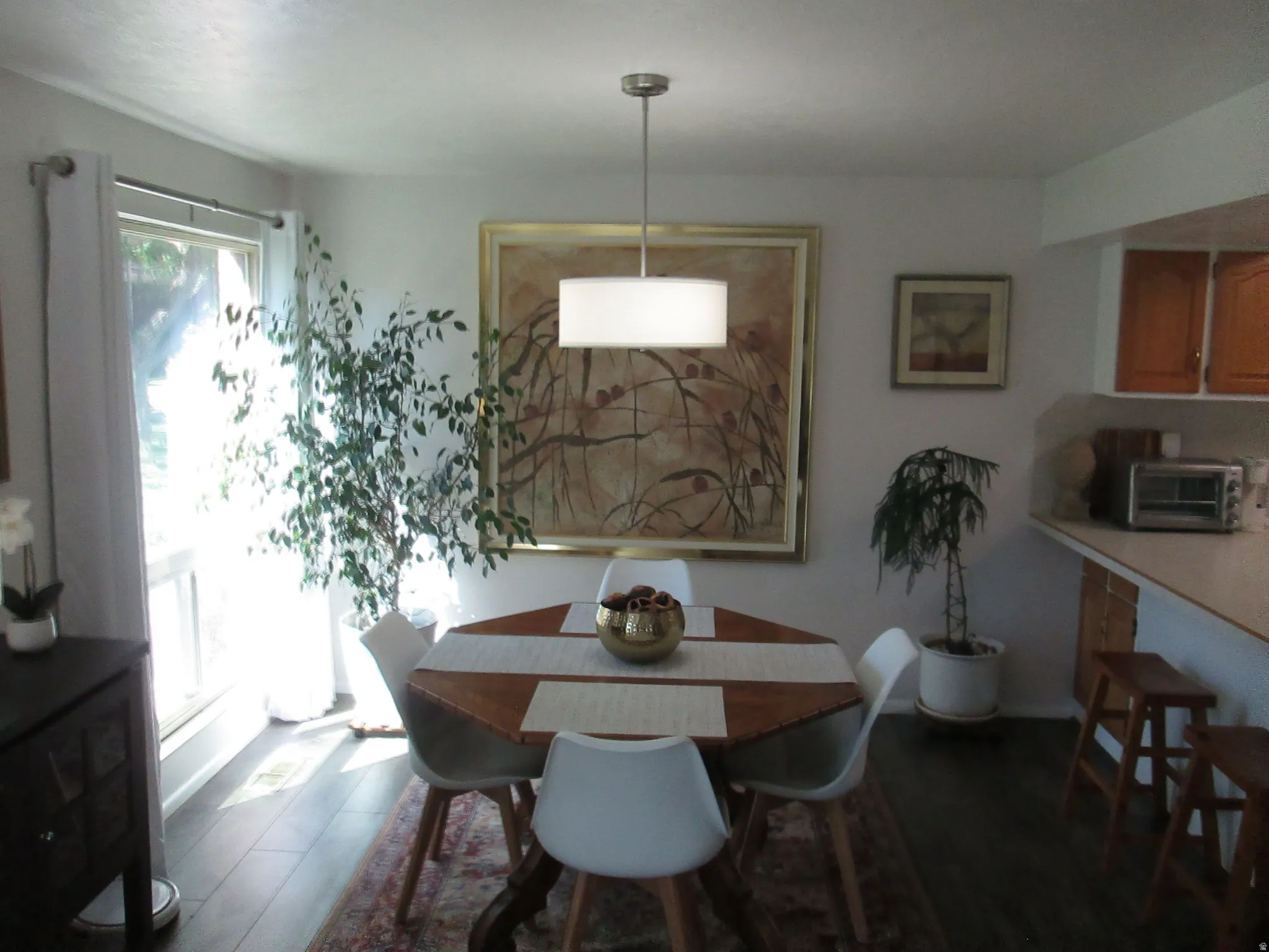 Wood-finish flooring, recessed lighting, and a pendant light fixture