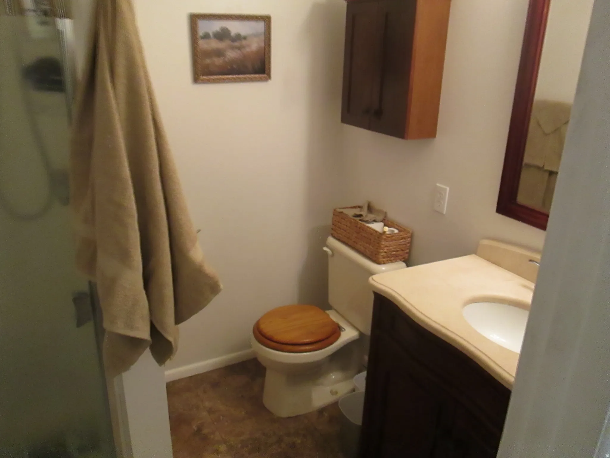 Dark wood vanity with an integrated sink and light-toned countertop