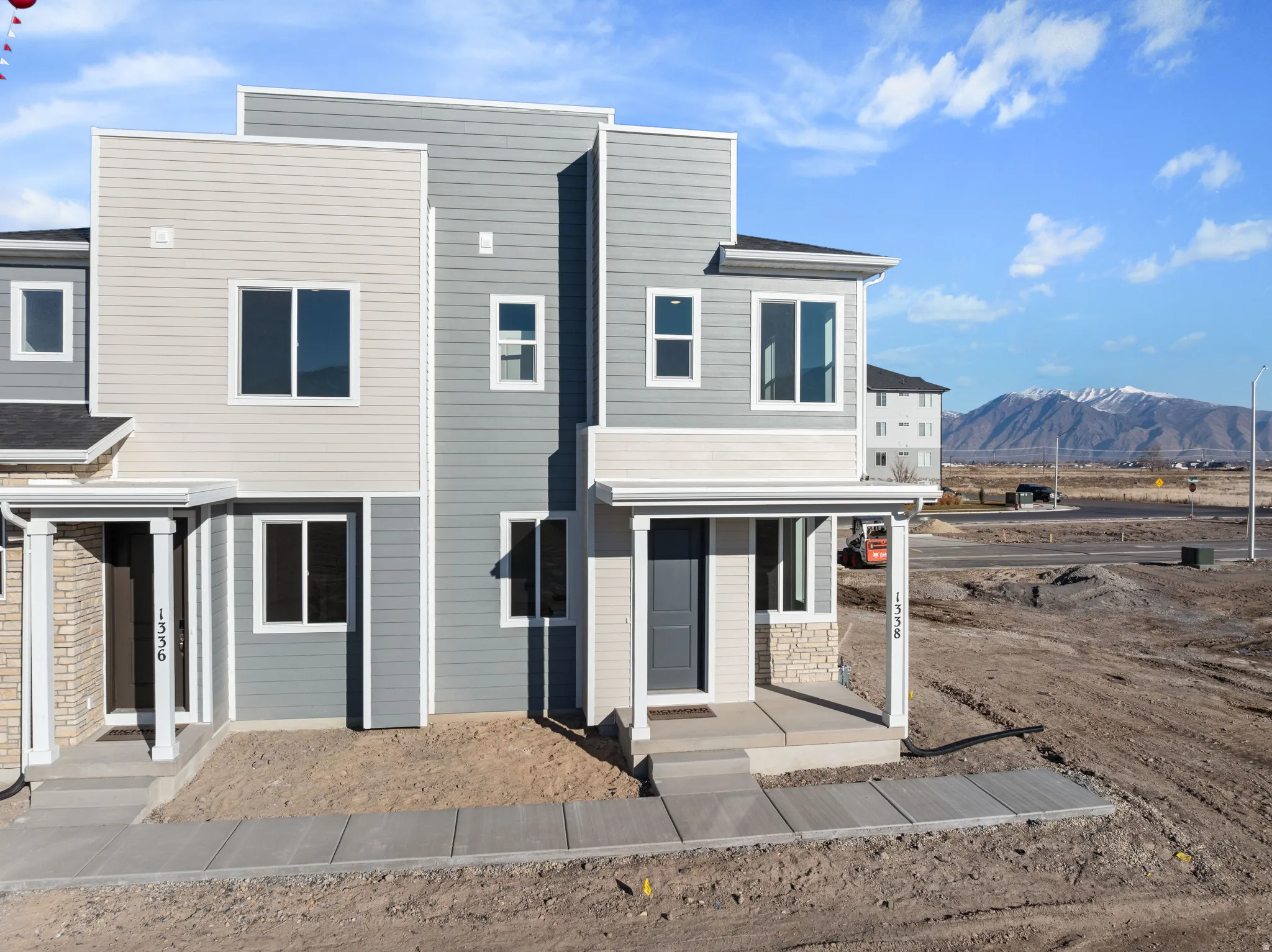 Contemporary townhome exterior featuring multi-toned horizontal siding
