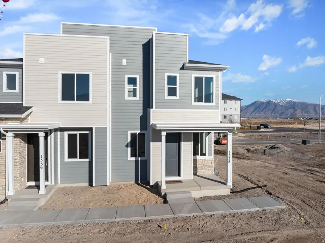 Contemporary townhome exterior featuring multi-toned horizontal siding