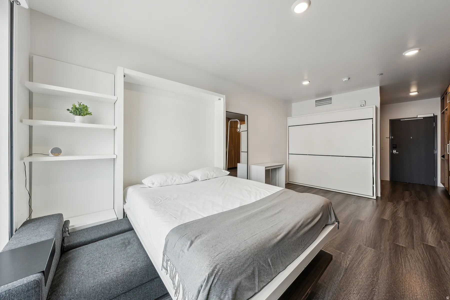 Built-in shelving, recessed ceiling lights, and wood-finish flooring
