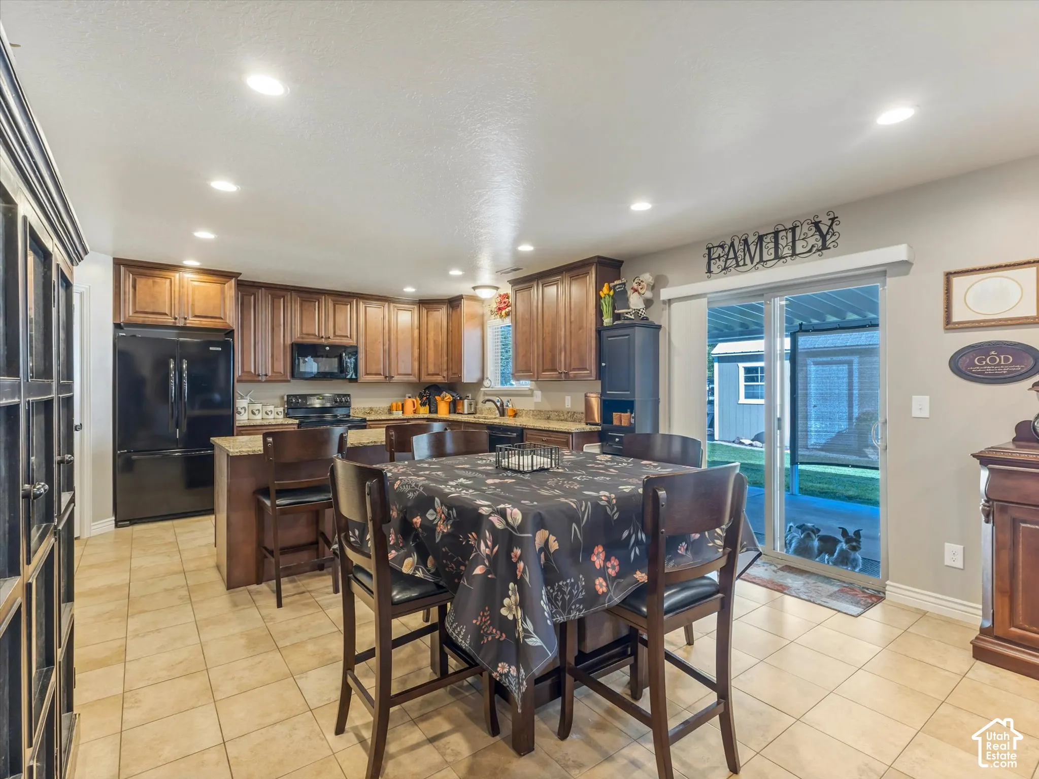 Kitchen featuring wood cabinetry, integrated appliances, recessed lighting, and tile flooring