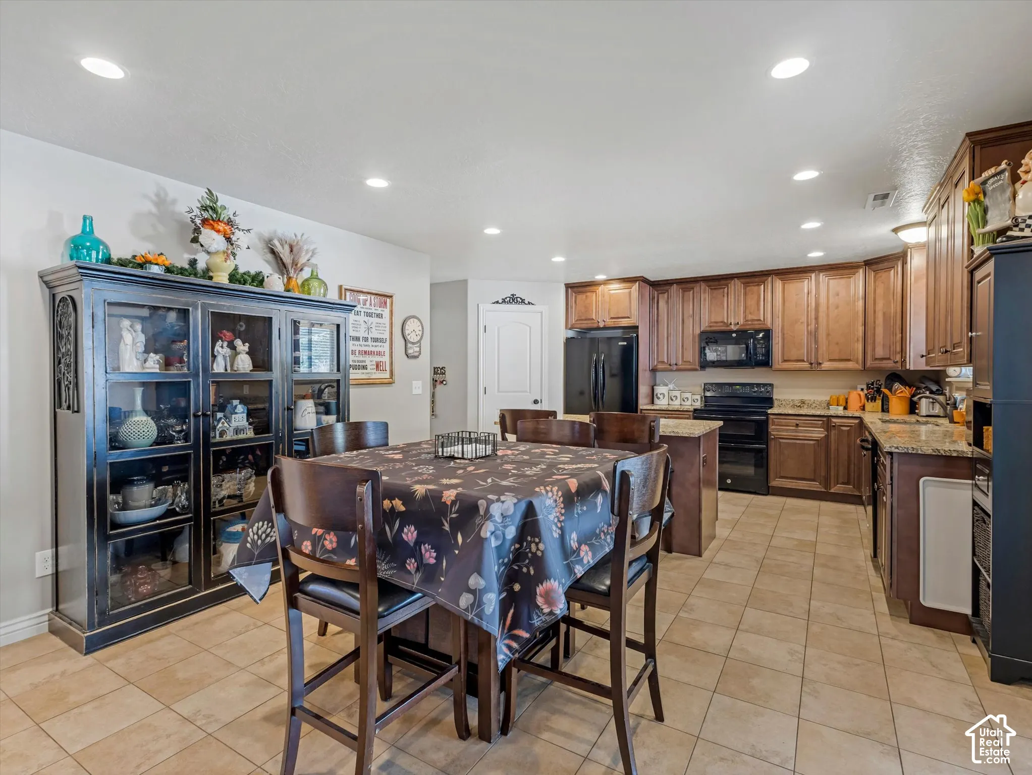 Kitchen featuring recessed lighting, extensive wood cabinetry, and solid surface countertops