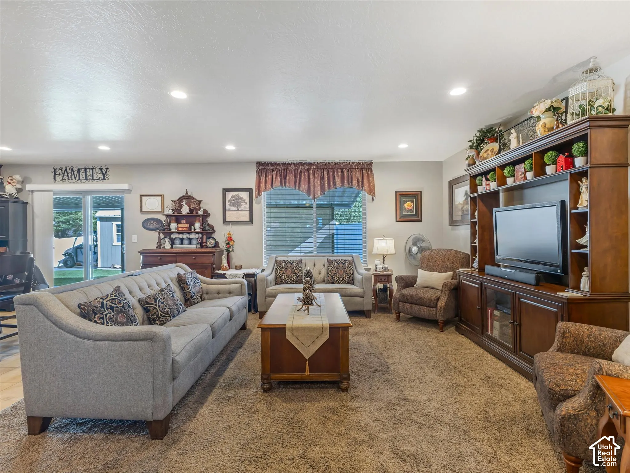 Recessed ceiling lighting, sliding glass door, and window with blinds