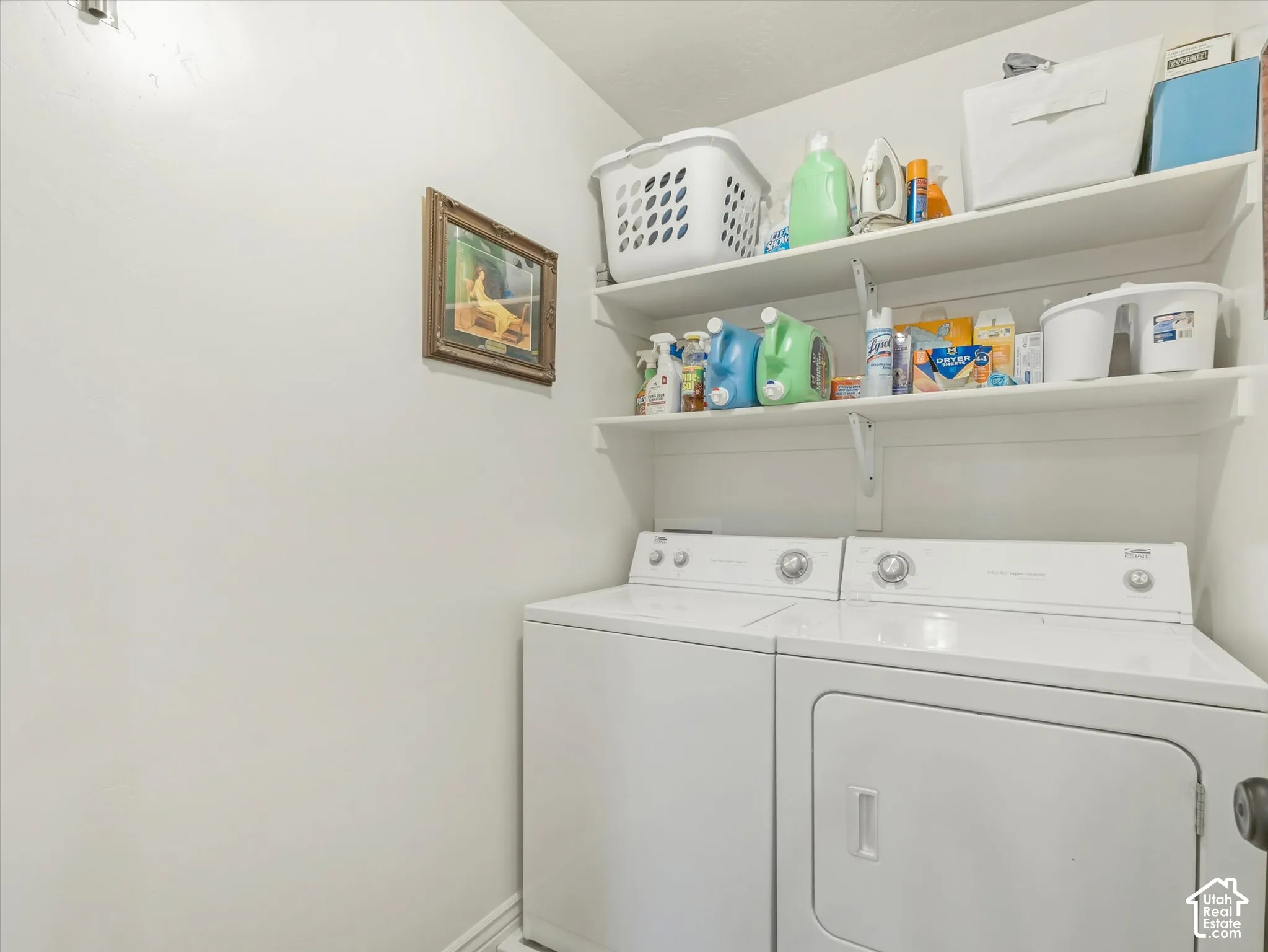 White washer and dryer units with upper wall-mounted shelving