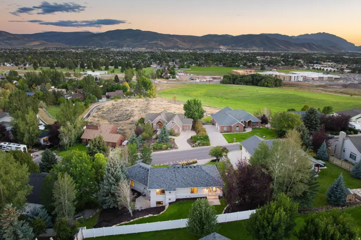 Residential neighborhood with a mountain backdrop, mature trees, and a mix of architectural styles