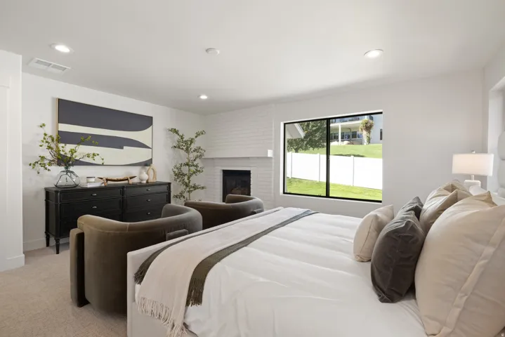 Recessed lighting, large window, built-in fireplace, white brick surround, dark wood dresser