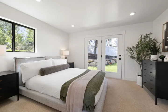 Recessed lighting, wood-finish flooring, white walls, and French doors leading to exterior
