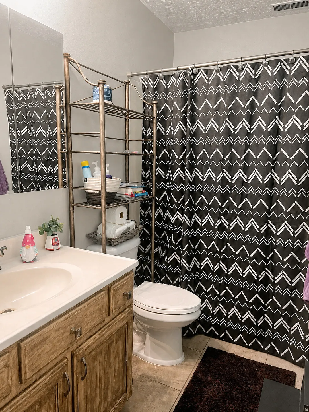 Wood-finish vanity with a white countertop and an integrated sink