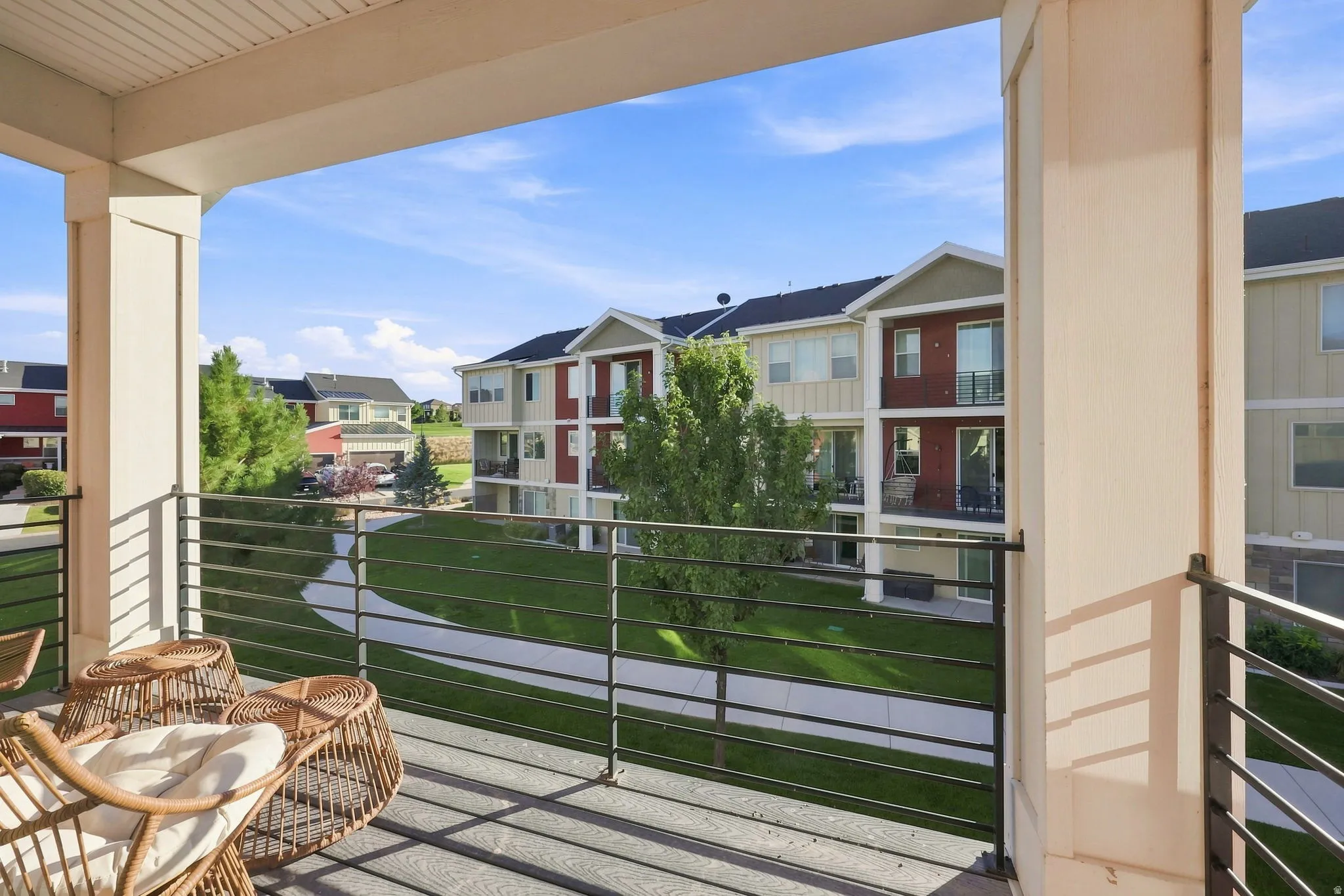 Private balcony with a slatted railing, providing open-air outdoor living space
