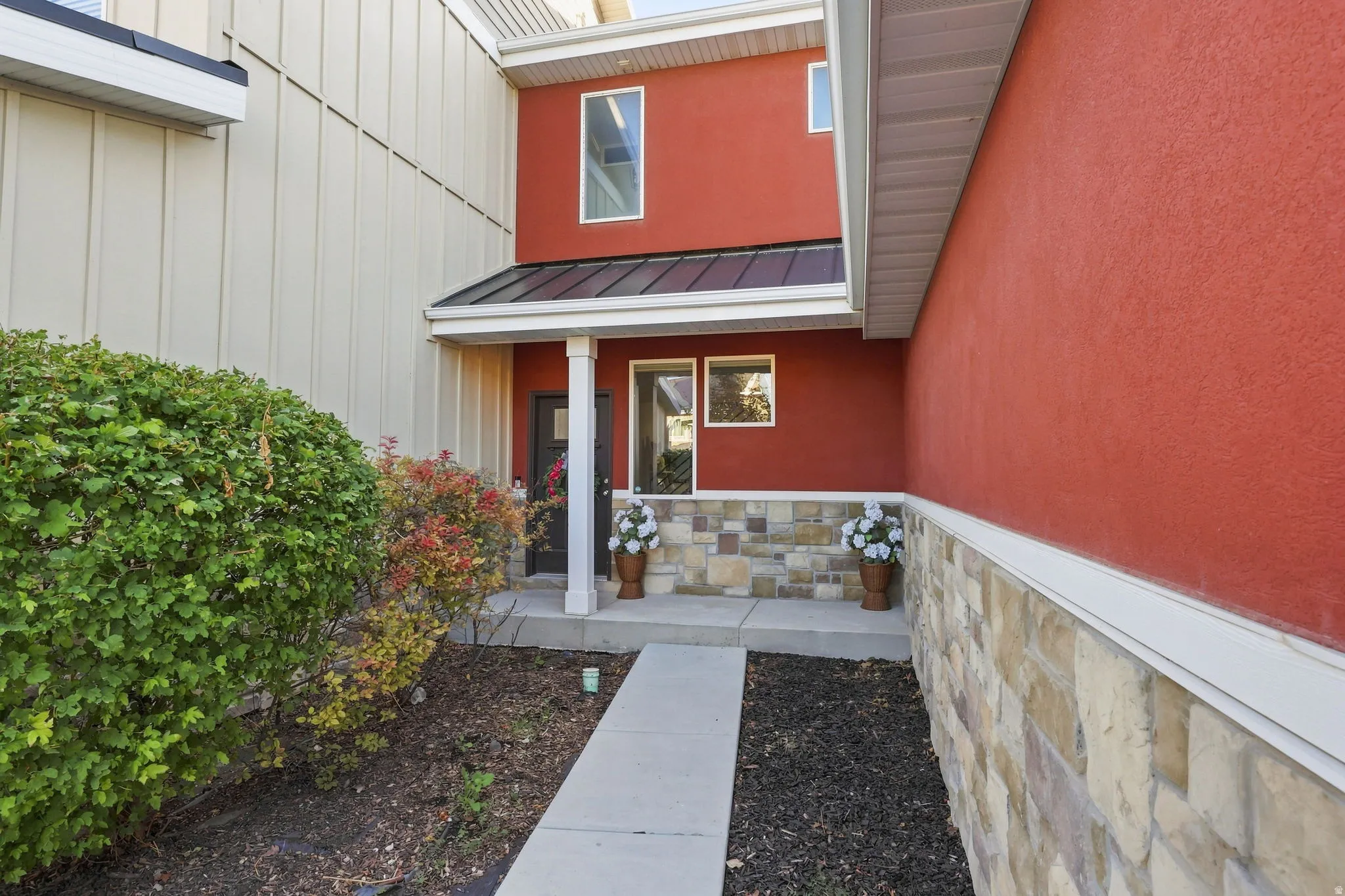 Red stucco exterior with complementary light-colored siding