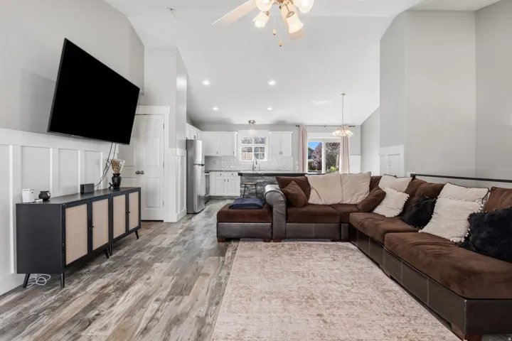 Wood-finish flooring throughout the main living area, complemented by white board and batten wall detailing