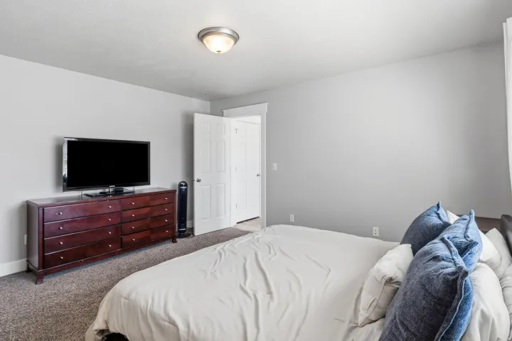 Neutral wall color, carpeted flooring, and a flush mount ceiling light