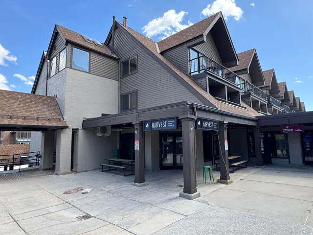 Multi-level building with shingled roofing and horizontal siding