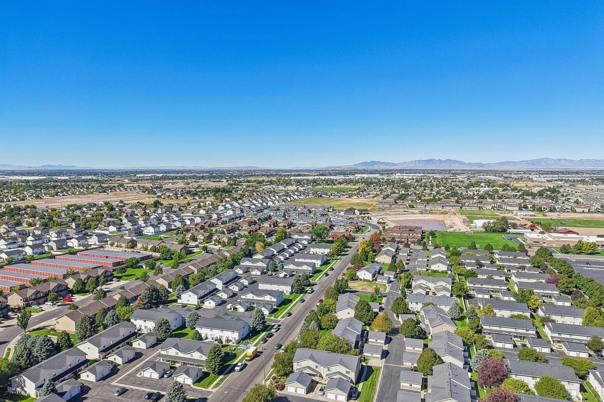 Expansive residential area with a clear sky and distant mountains
