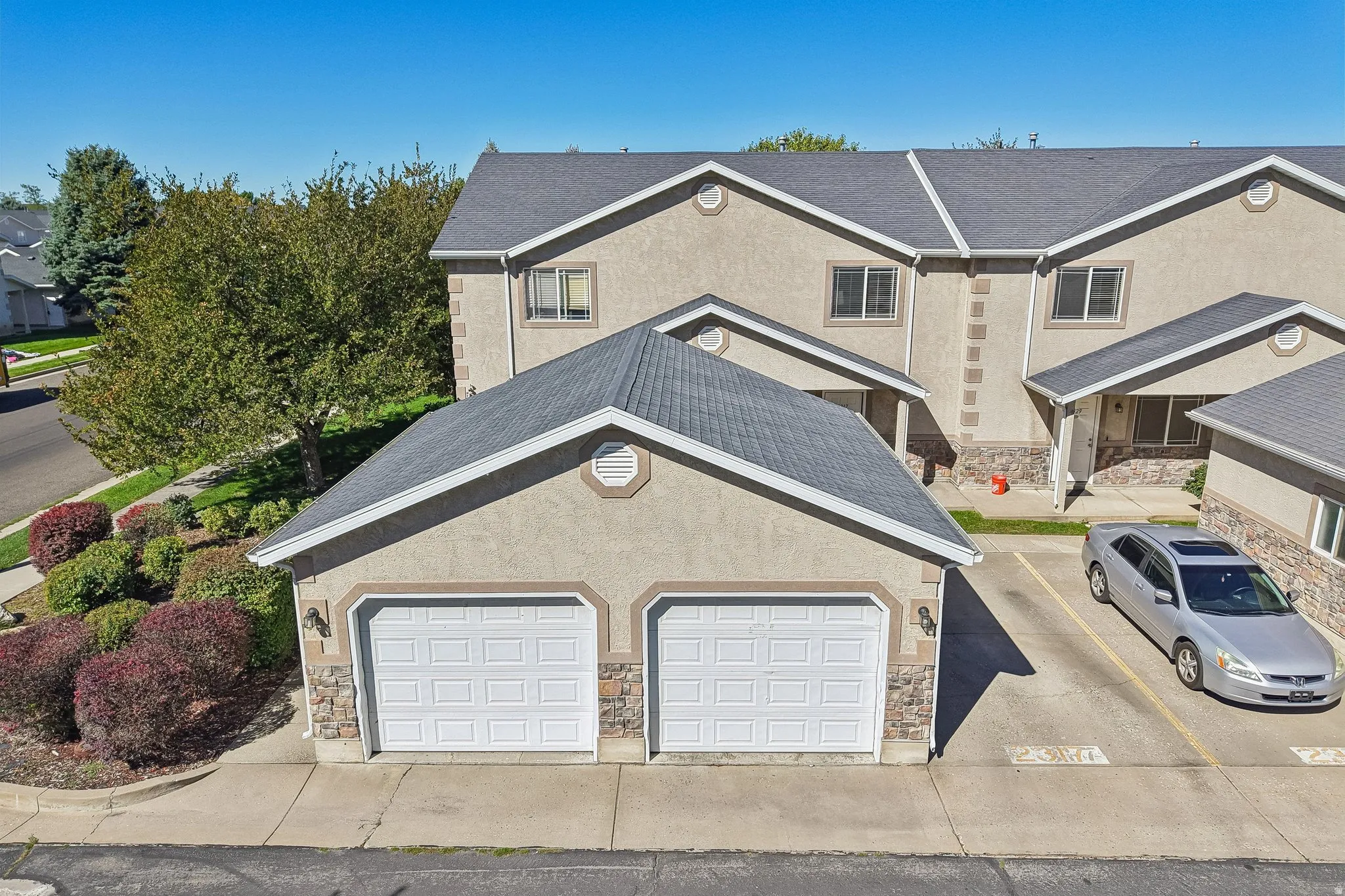 Two-car detached garage with stucco and stone veneer