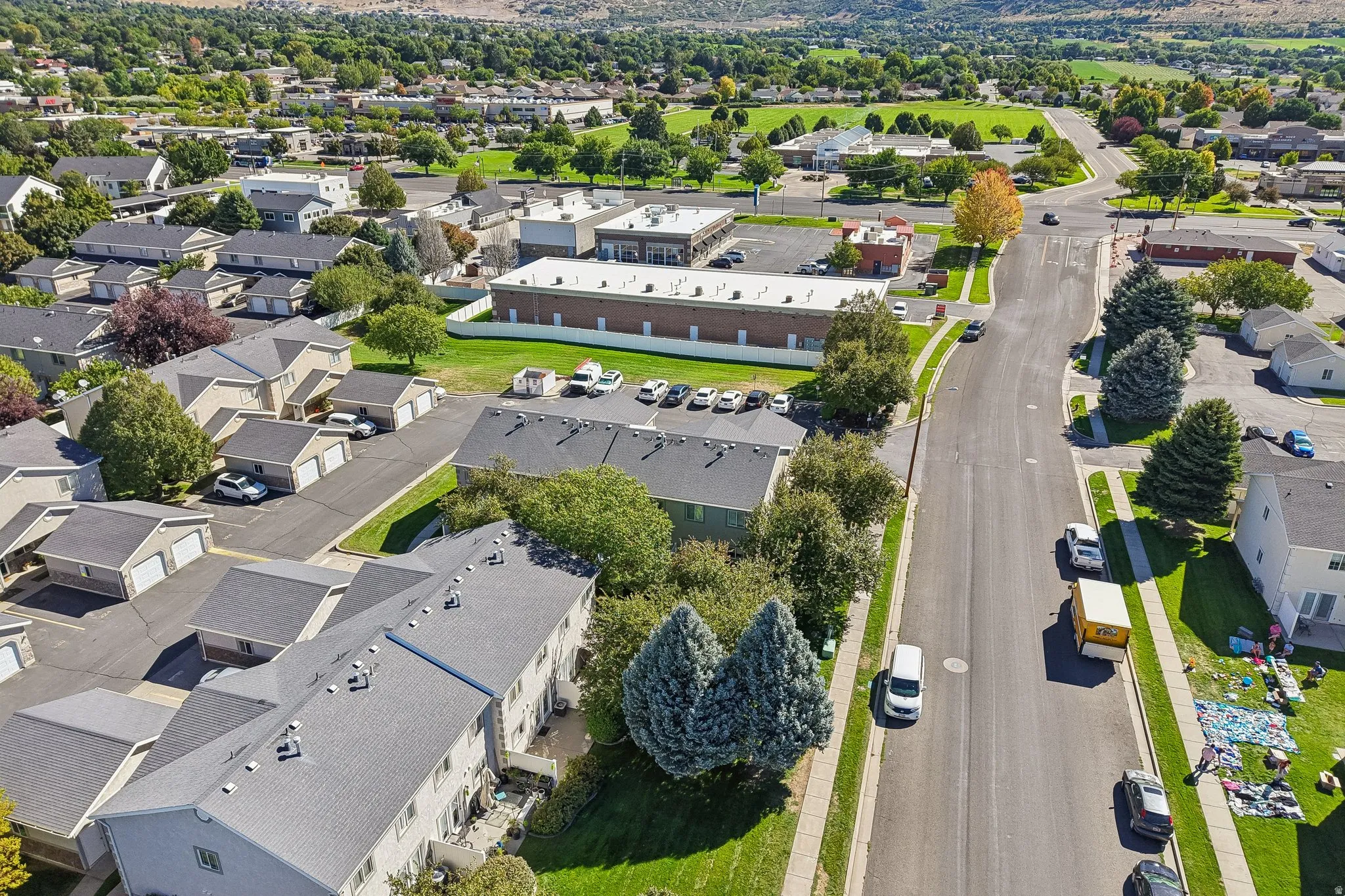 Aerial perspective showcasing residential buildings, paved streets, and green spaces