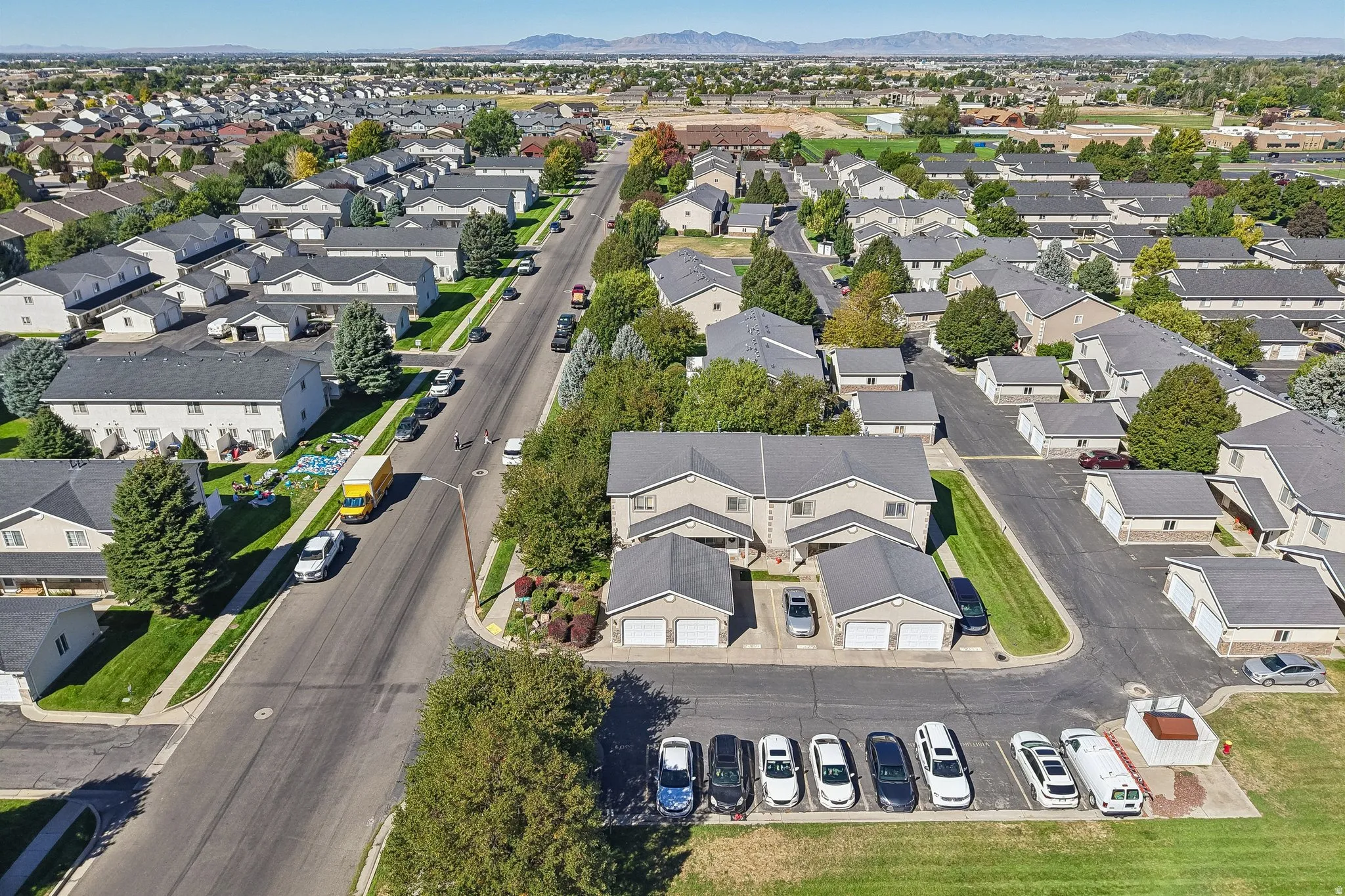 Residential neighborhood with detached garages, paved streets, and mature trees