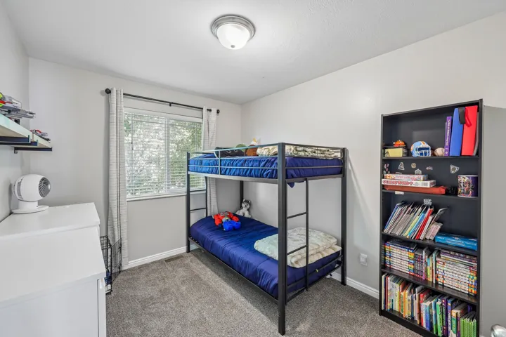 Window with white blinds, gray wall paint, and gray carpeting