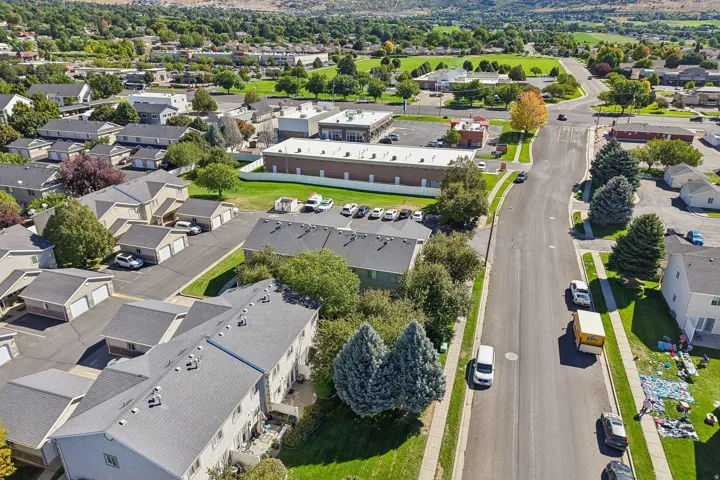 Aerial perspective showcasing residential buildings, paved streets, and green spaces