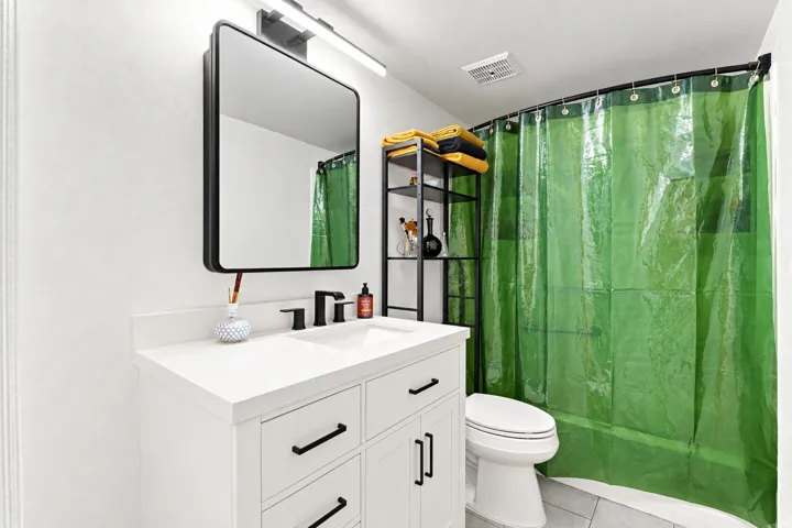 Full Bathroom with new tile flooring, new vanity, new toilet, mirror with medicine cabinet and new lighting.