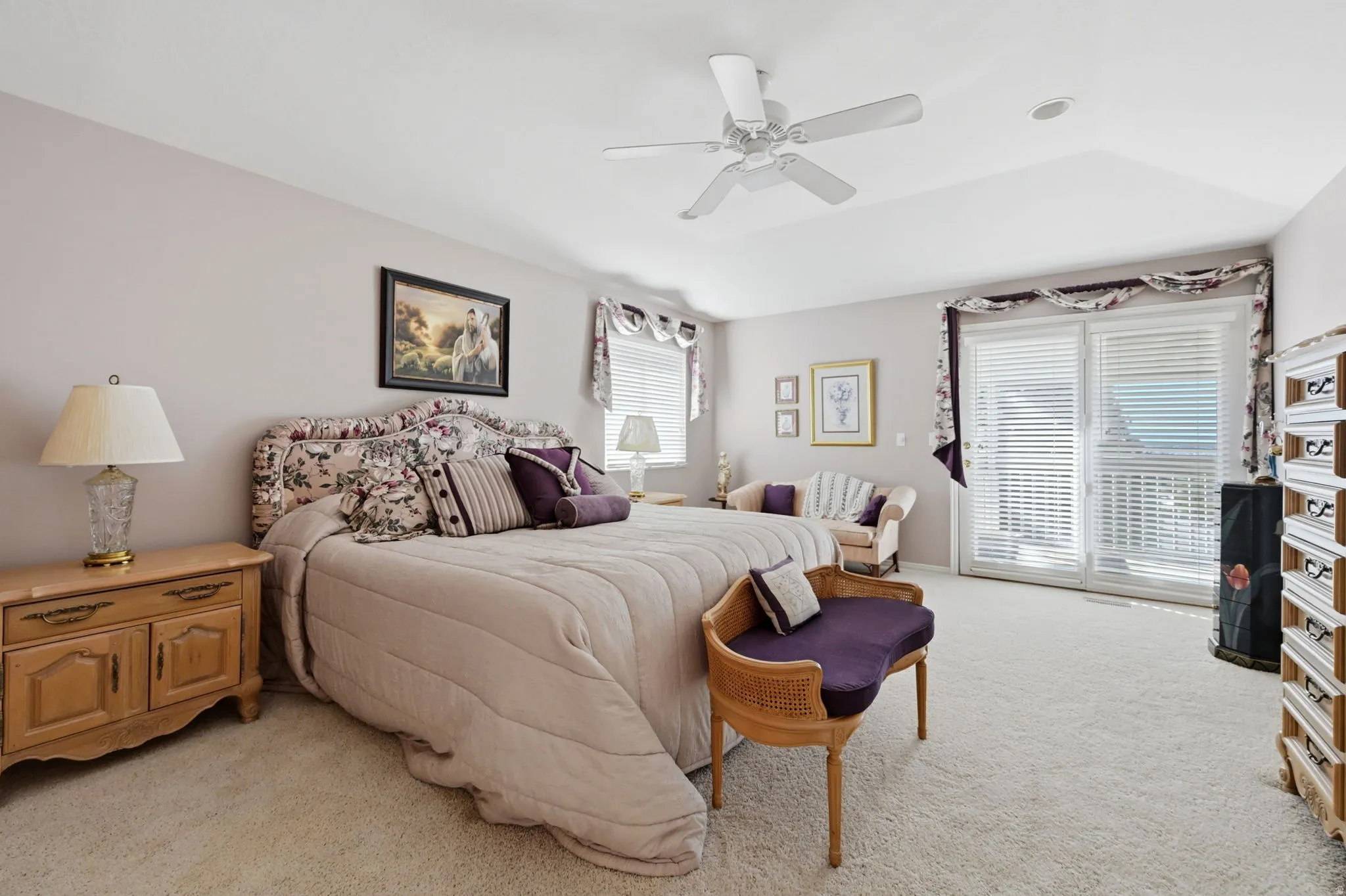Huge primary bedroom with tray ceiling, an integrated ceiling fan and recessed lighting