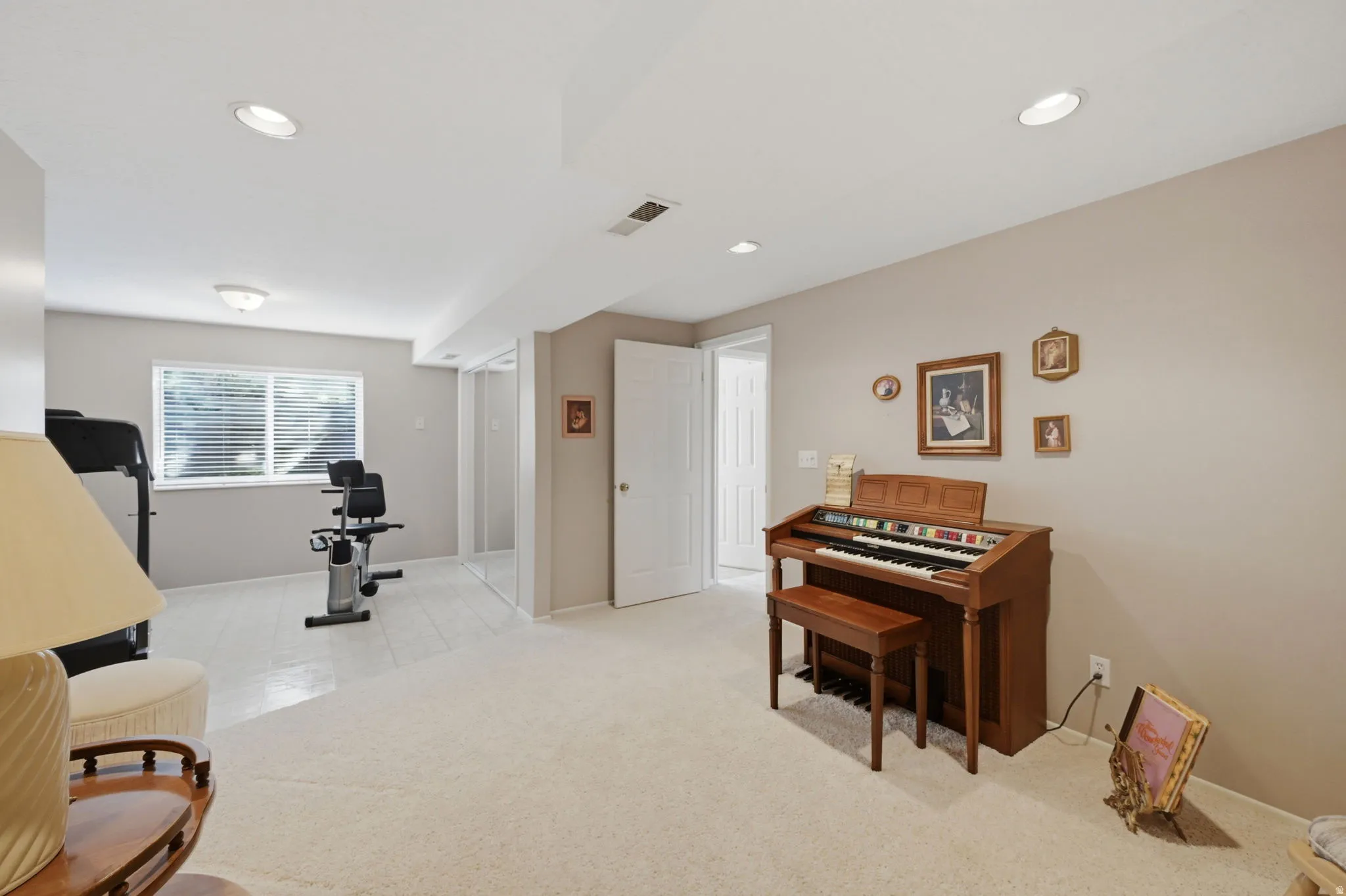 Large bedroom or office/exercise room,  recessed lighting, neutral wall paint, carpet flooring, a window with blinds, and white trim
