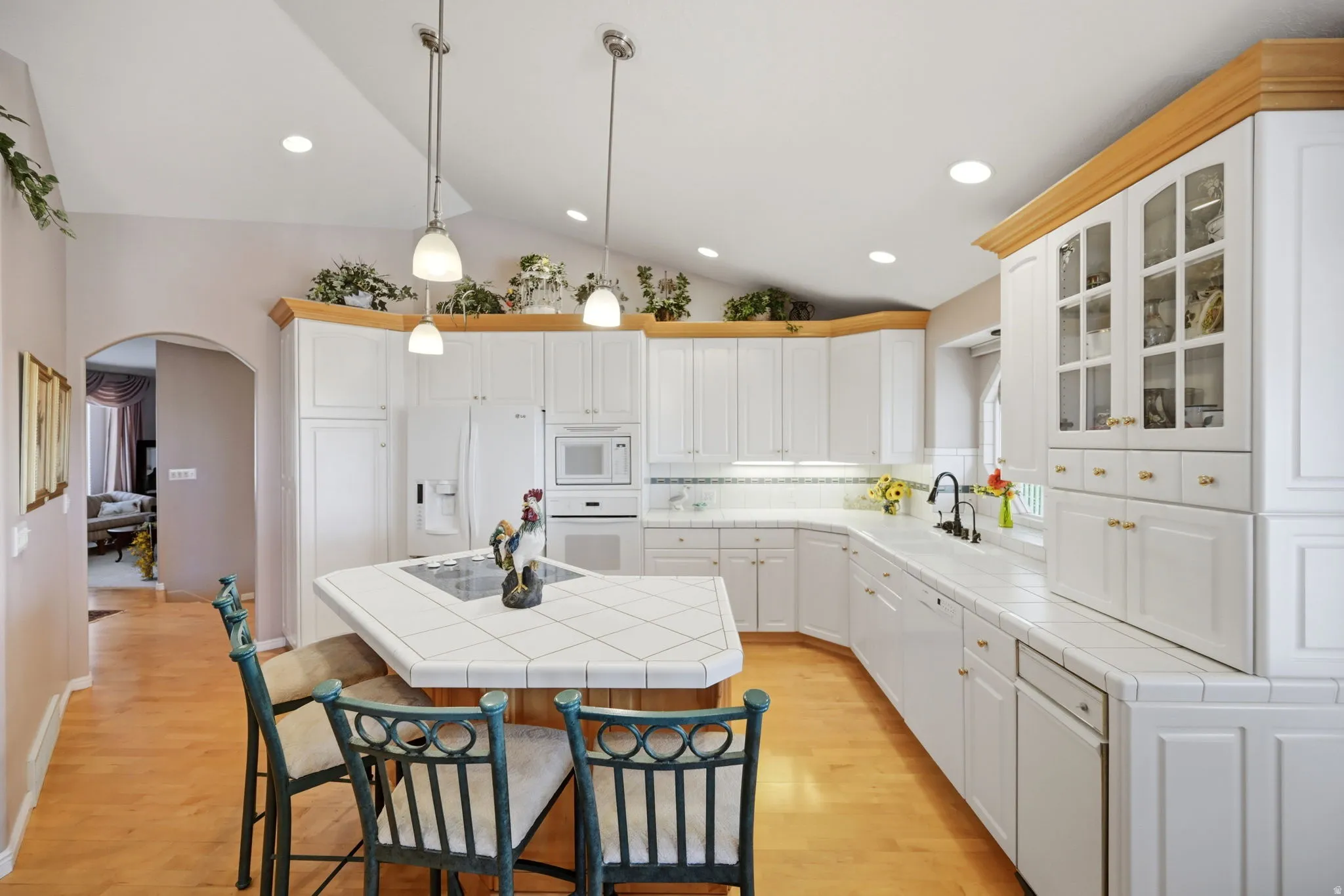 Vaulted ceiling with recessed lighting and pendant fixtures