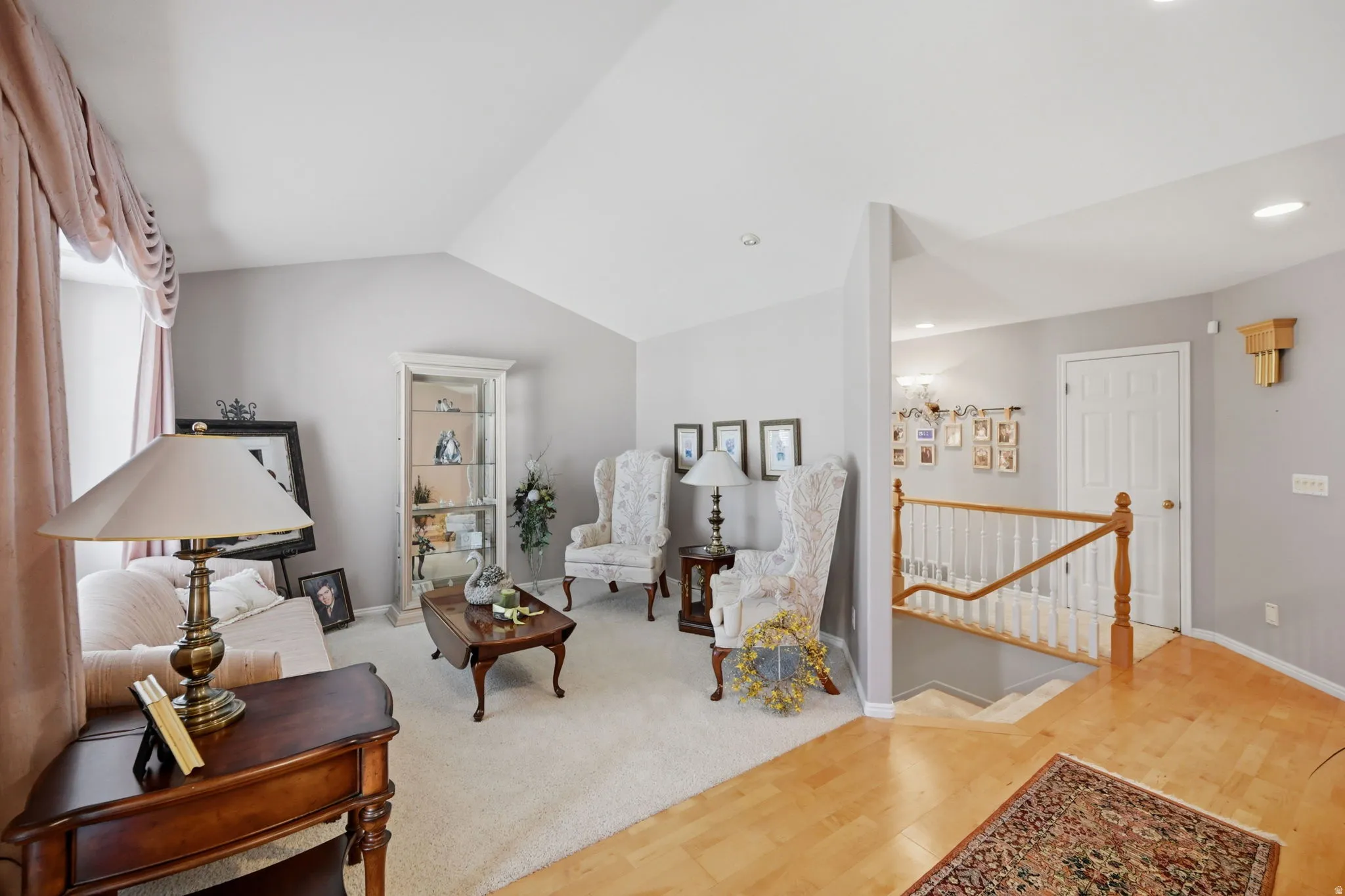 Vaulted ceilings, light neutral wall tones, hardwood flooring