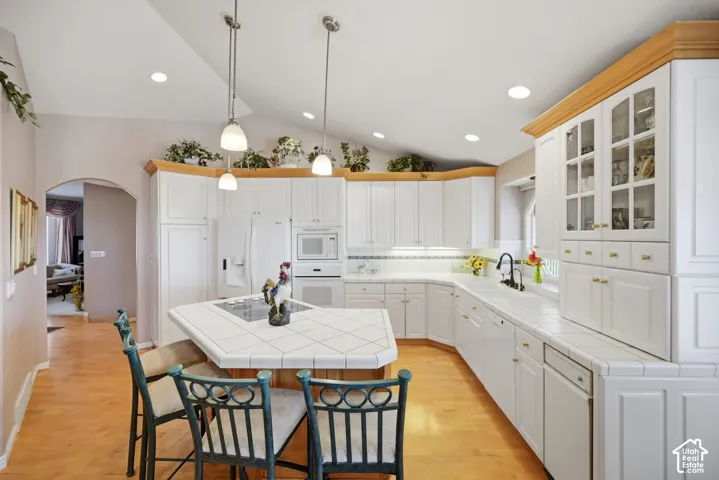 Vaulted ceiling with recessed lighting and pendant fixtures