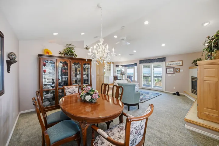 Open-concept living space with recessed lighting and expansive sliding  glass doors to the balcony