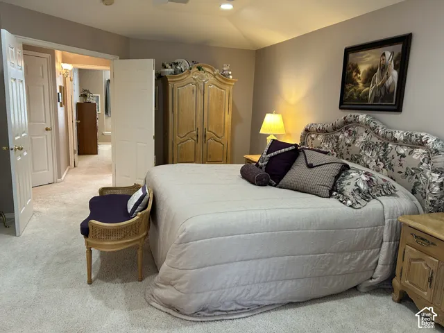 Neutral wall tones, recessed lighting, and wall-to-wall carpeting