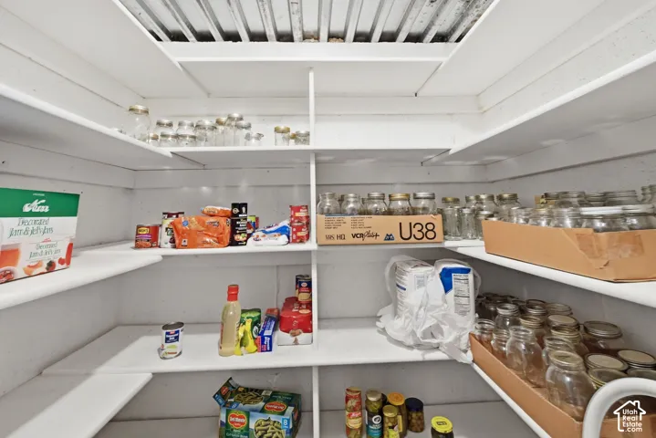 Large pantry with built-in pantry shelving and white wood construction