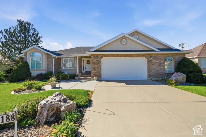 Brick and stucco exterior with an oversized two-car garage